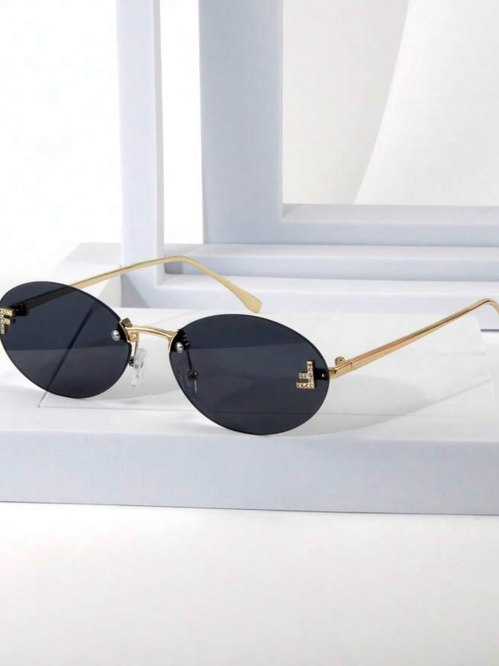 Rimless Oval Black Lens Sunglasses with Gold Temples
